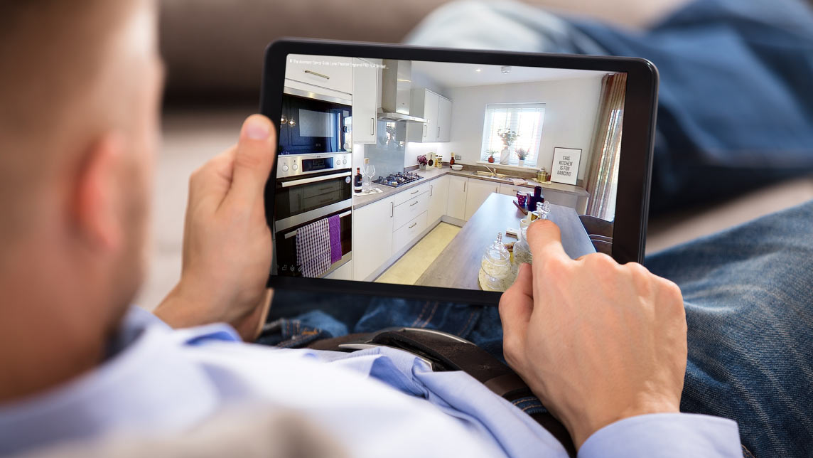 Gentleman uses tablet to navigate through a 3D walkthrough of a house