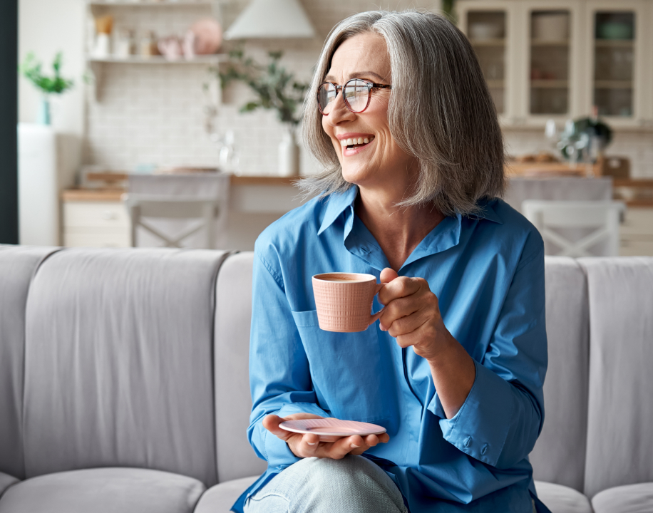 An older lady relaxing with a hot drink