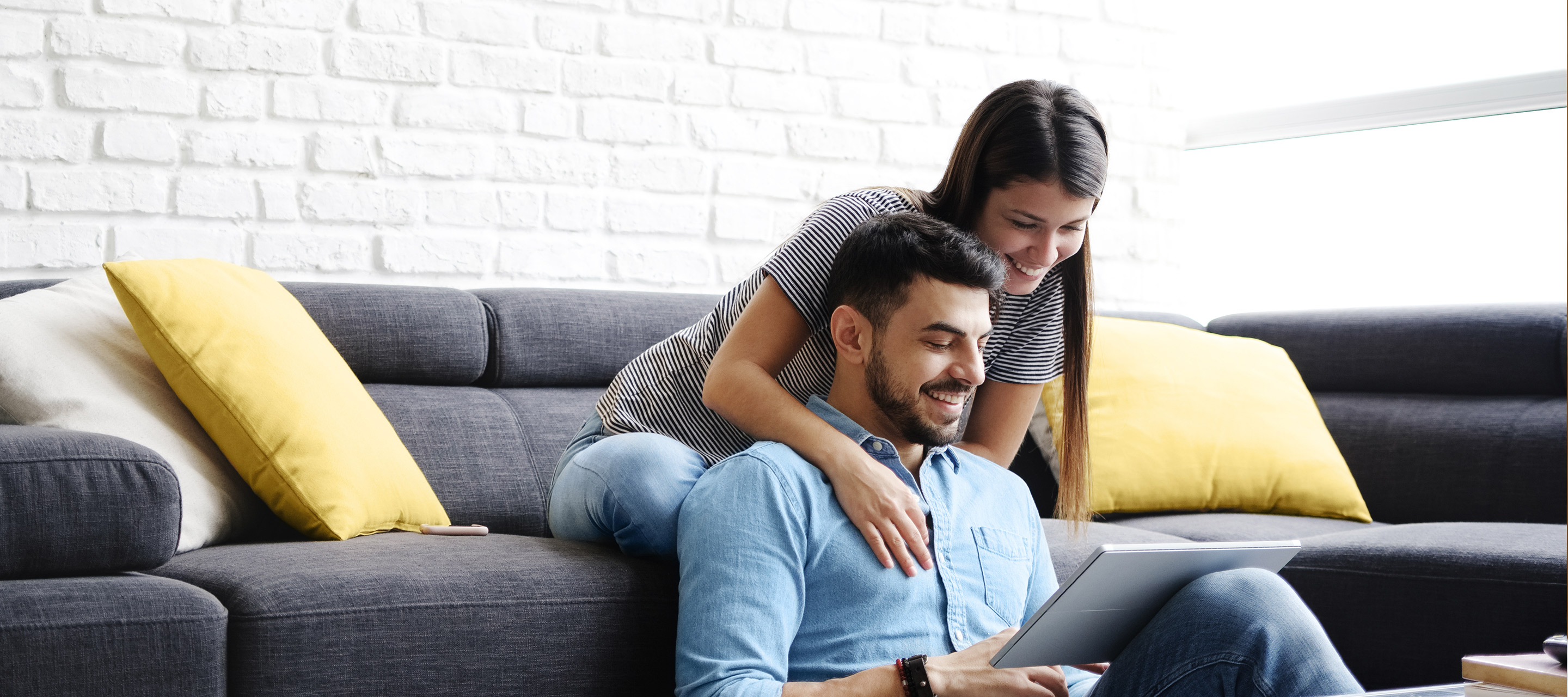 Couple reviewing Purplebricks packages on a tablet